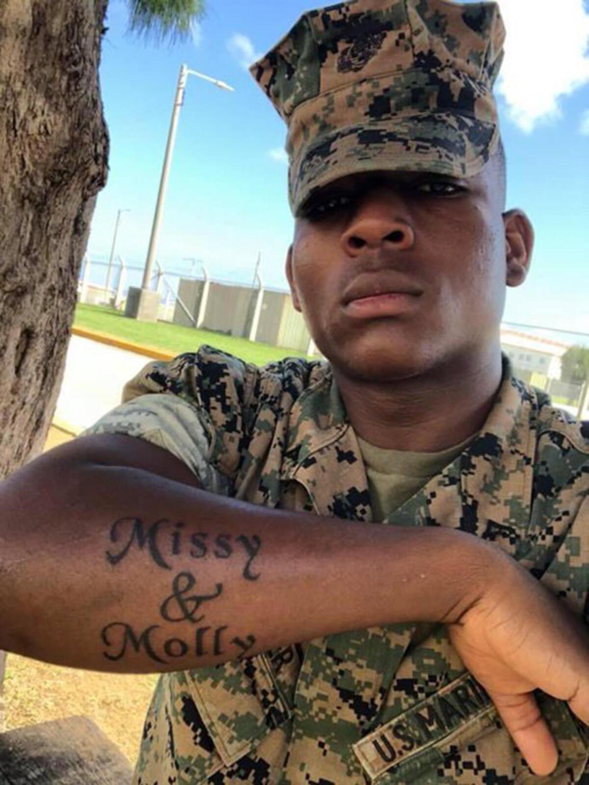 Keivonn Monger showcases a tattoo he received in 2018 of the names of his two foster parents.