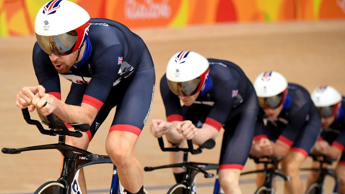Britain's Bradley Wiggins leads teammates Edward Clancy, Steven Burke and Owain Doull as they compete in the men's team pursuit finals Friday.