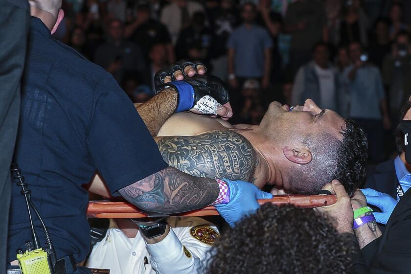 Chris Weidman leaves the octagon on a stretcher after a UFC 261 mixed martial arts fight, Saturday, April 24, 2021, in Jacksonville, Fla. This is the first UFC event since the onset of the COVID-19 pandemic to feature a full crowd in attendance. (AP Photo/Gary McCullough)
