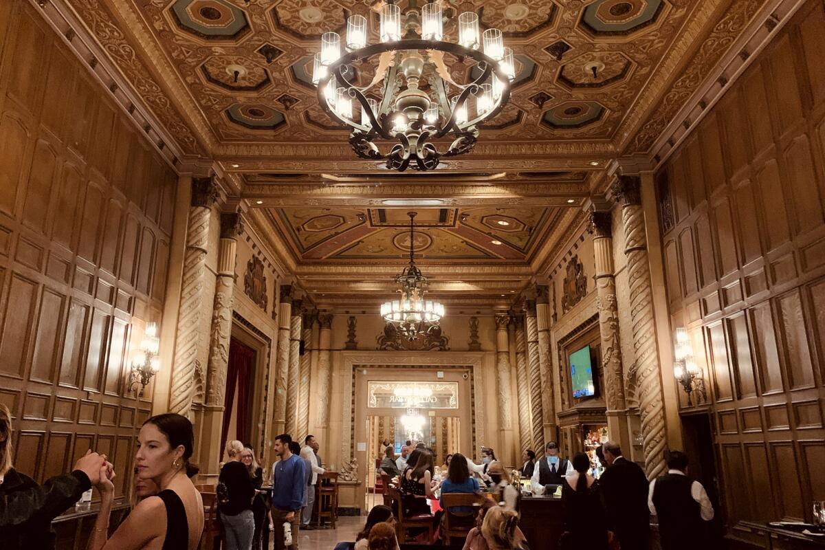 An ornate ballroom at the Biltmore filled with people. 
