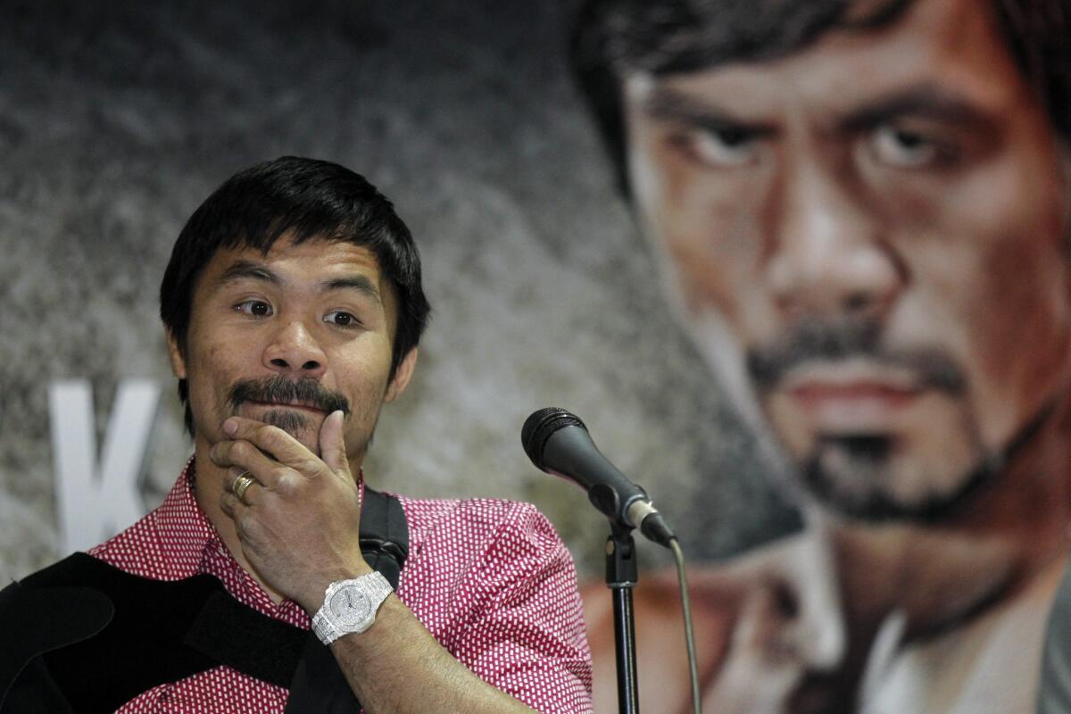 Filipino boxing icon Manny Pacquiao speaks to the media upon his arrival at the Ninoy Aquino International airport in Manila, Philippines, on May 13, 2015.