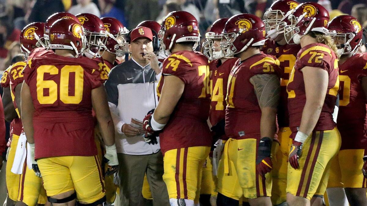 USC coach Clay Helton speaks to his players during a game against UCLA on Nov. 19.