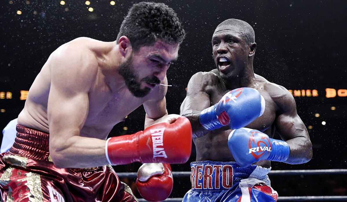 Andre Berto, right, shown in action against Josesito Lopez in 2015, has dropped the price of his Beverly Hills home again