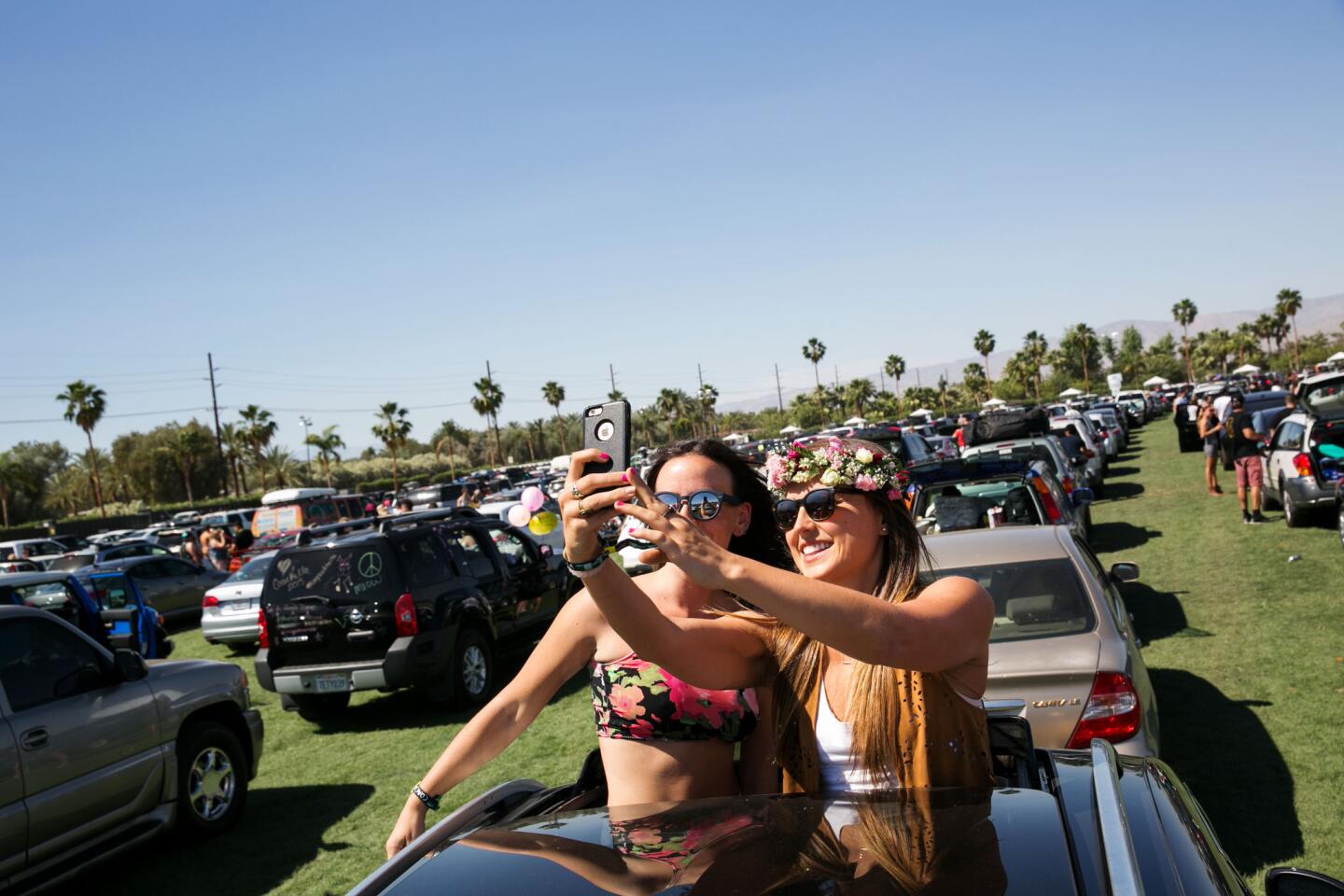 Music fans capture the moment as they wait to get into the Coachella campgrounds in Indio on Thursday ahead of the festival's first weekend.