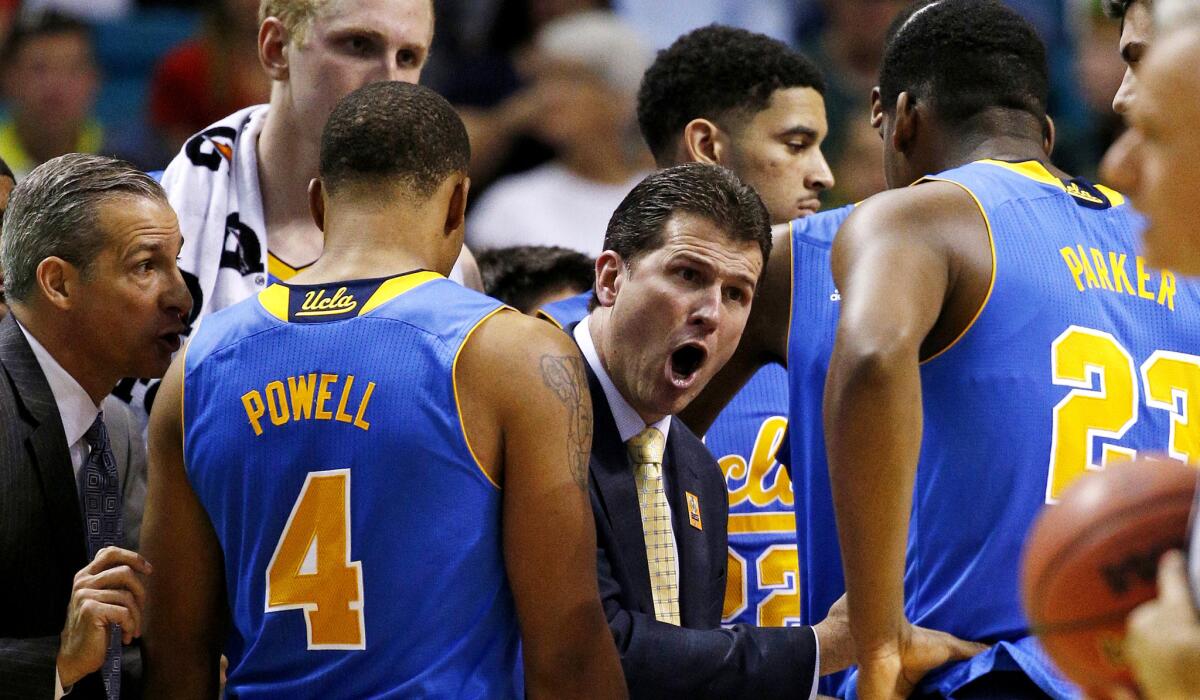 UCLA Coach Steve Alford talks to his players during a timeout in the second half of their Pac-12 semifinal against Arizona on Friday night.