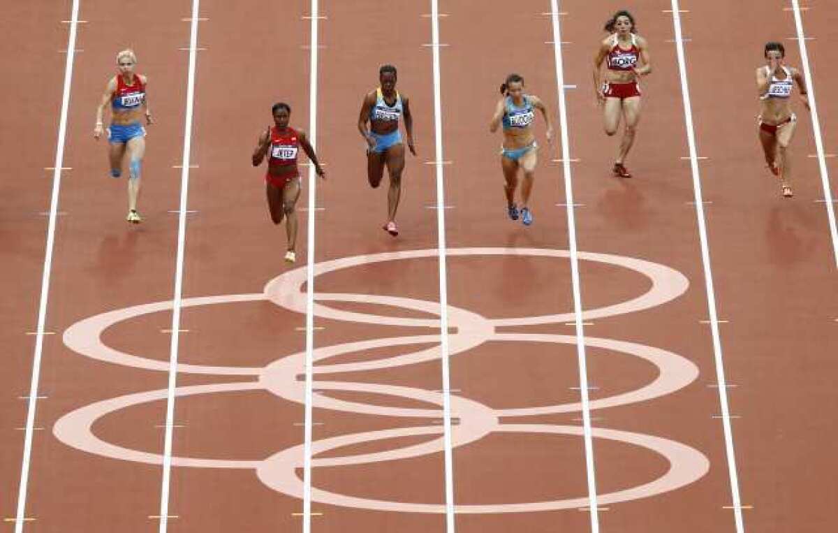 From left, Russia's Olga Belkina, United States' Carmelita Jeter, Bahamas' Sheniqua Ferguson, Kazakhstan's Olga Bludova, Malta's Diane Borg and Poland's Marta Jeschke compete in a women's 100-meter heat Friday.