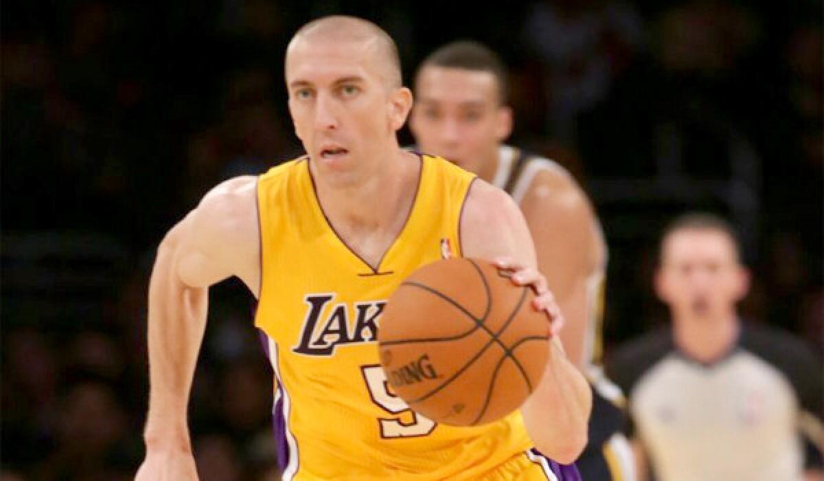 Steve Blake brings the ball up the floor during the Lakers' 108-94 win over the Utah Jazz in a preseason exhibition game Tuesday.