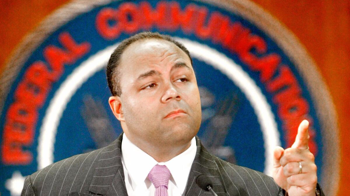 Federal Communications Commission Chairman Michael Powell gestures during a 2003 news conference (Ron Edmonds / Associated Press)