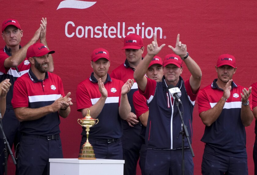 FILE - Team USA captain Steve Stricker holds up a "W" for Wisconsin at the closing ceremony after the Ryder Cup matches at the Whistling Straits Golf Course on Sept. 26, 2021, in Sheboygan, Wis. Stricker is recovering from a major health scare that hospitalized him for two weeks with inflammation of the heart. (AP Photo/Charlie Neibergall, File)