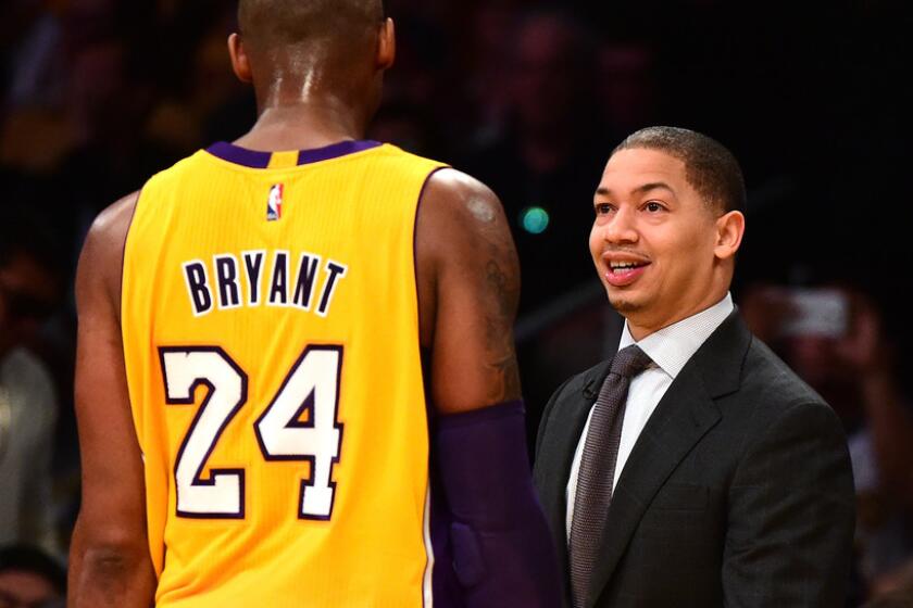 Lakers star Kobe Bryant and Cavaliers coach Tyronn Lue exchange greeting during a game in 2016.