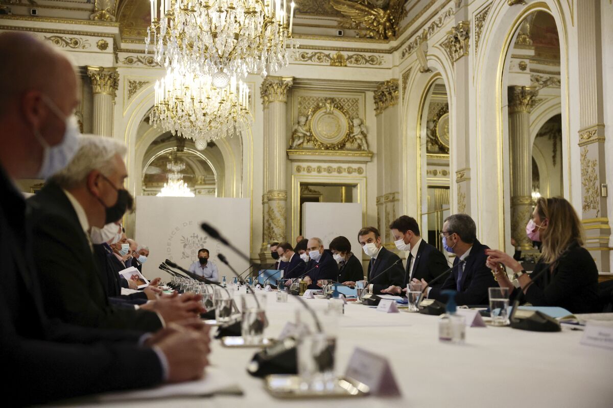 French President Emmanuel Macron, fourth from right, attends a meeting, at the Elysee Palace in Paris, Friday, Dec. 17, 2021. France, December 17, 2021. Macron met with a delegation of French fishermen on Friday amid months-long, unresolved fishing dispute with Britain. (Sarah Meyssonnier, Pool photo via AP)
