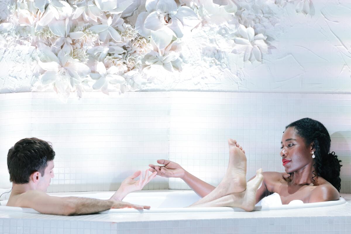 Anthony Roth Costanzo and Nardus Williams sit in a bathtub during a production of "The Comet / Poppea."