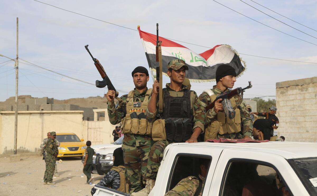 Sunni volunteer fighters parade through Khalidiya, located 60 miles west of Baghdad, as they prepare to support Iraqi security forces in liberating the city of Ramadi from Islamic State group militants on Oct. 10.