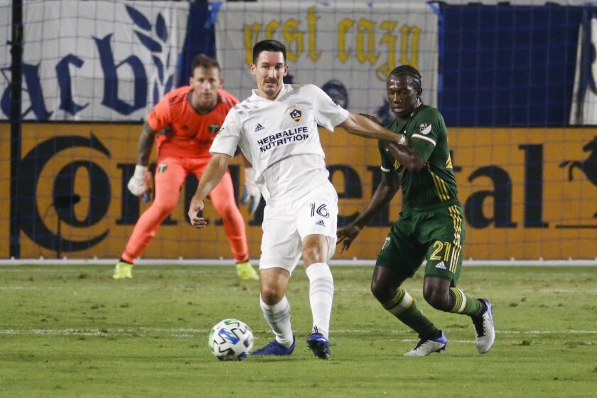 LA Galaxy midfielder Sacha Kljestan (16) and Portland Timbers midfielder Diego Chara (21) of Colombia, in actions during an MLS soccer match between LA Galaxy and Portland Timbers in Carson, Calif., Wednesday, Oct. 7, 2020. The Timbers won 6-3. (AP Photo/Ringo H.W. Chiu)