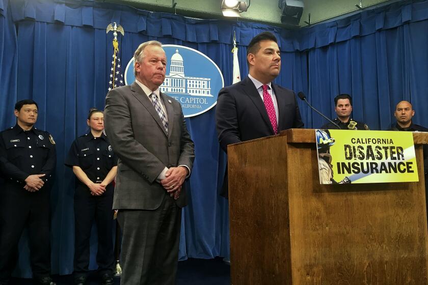 Democratic state Sen. Bill Dodd of Napa, left, and Insurance Commissioner Ricardo Lara, right, at the podium, speak at a news conference as Sacramento City Fire Department firefighters stand behind in the state Capitol in Sacramento, Calif., Thursday, Feb. 14, 2019. The two statewide officials want California to take out insurance to help cover taxpayers' costs in bad wildfire seasons. California has experienced 11 of the top 20 most destructive fires in its history since 2007. (AP Photo/Don Thompson)