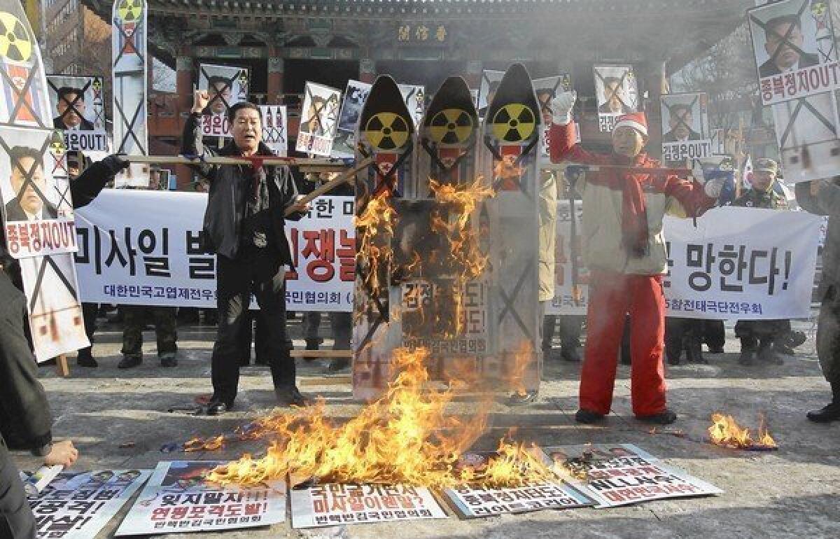 South Koreans in Seoul burn an image of North Korean leader Kim Jong Un and representations of a North Korean missile as they protest the North's rocket launch this week.