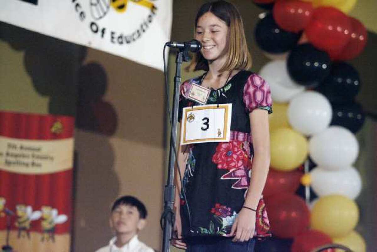 Palm Crest Elementary School's Solenn Matuska spells out a word during the Seventh Annual Los Angeles County Elementary Spelling Bee contest, which took place at the Almansor Court Conference Center in Alhambra. Matuska won the spelling bee contest.