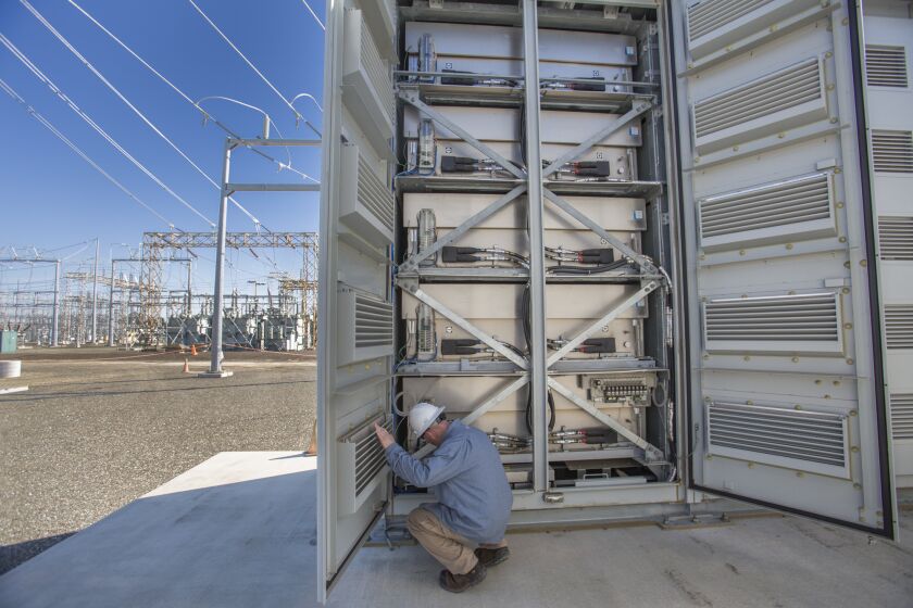 David Doss, a Pacific Gas & Electric employee, looks over stacks of battery cells, part of an experimental project in Vacaville, Calif., looking at ways to store renewable energy. The stacks can store enough electricity to power 1,400 homes for a full day.