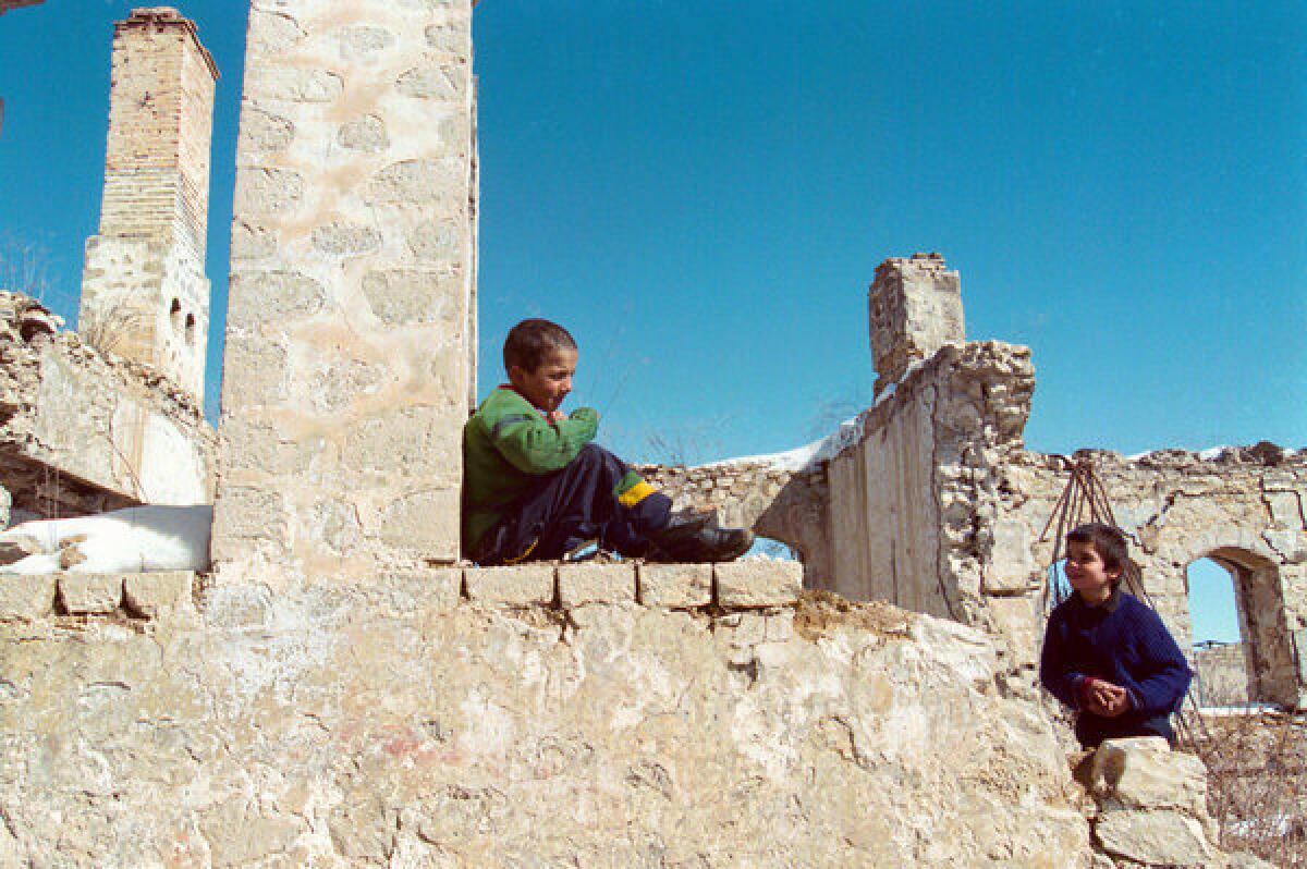 Armenian children play in the ruins of ancient Shusha, a village destroyed during the 1991-94 war between Armenians and Azerbaijanis for Nagorno-Karabakh. The remote mountain enclave remains in dispute nearly two decades after a cease-fire froze fighting.