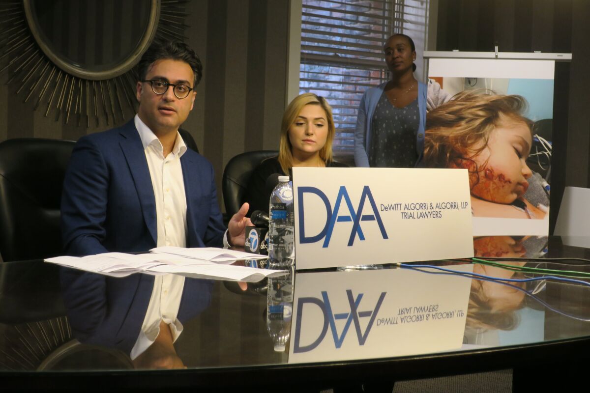 Attorney Sam Soleimany, left, with Bree Anne Lee Thacker Thursday explain their claims against the city of Huntington Beach.