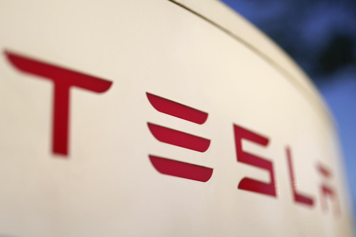A close-up view of the logo for a Tesla Supercharger station 