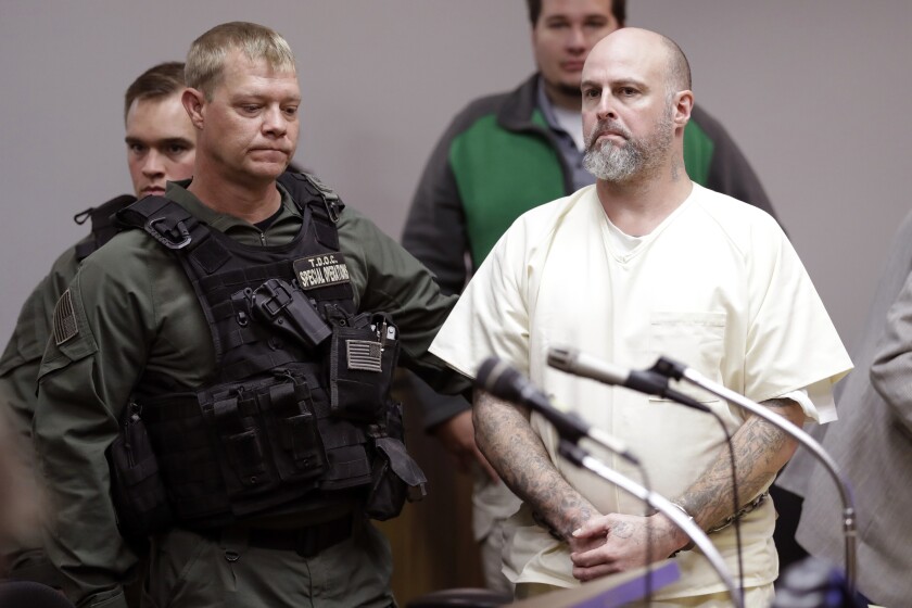 FILE - In this Wednesday, Nov. 20, 2019, file photo, Curtis Ray Watson, right, stands as a preliminary hearing is recessed in Ripley, Tenn. A prosecutor says a hearing has been set to discuss a plea deal for the Tennessee prison inmate charged with killing a corrections administrator during a 2019 escape attempt. Lauderdale County district attorney Mark Davidson told The Associated Press that a hearing has been scheduled for Monday, June 14, 2021, in the case of Watson. (AP Photo/Mark Humphrey, Pool, File)