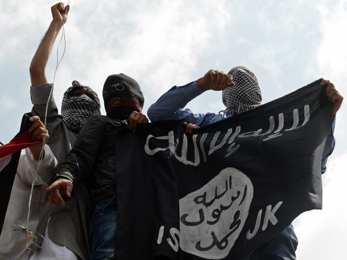 Demonstrators in the disputed Kashmir region hold up an Islamic State flag during a demonstration July 18, 2014. Al Qaeda says it is launching a new branch to "wage jihad" in South Asia.
