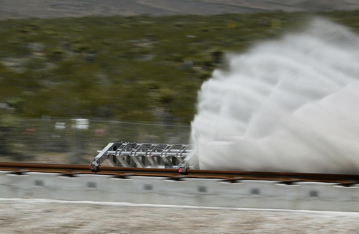 A sled speeds down a track during a demonstration of Hyperloop One's propulsion system in North Las Vegas in May.