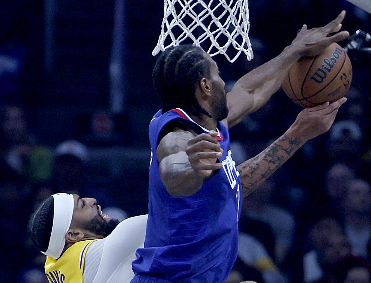Clippers forward Kawhi Leonard blocks a shot by Lakers forward Anthony Davis during Tuesday's game at Crypto.com Arena.