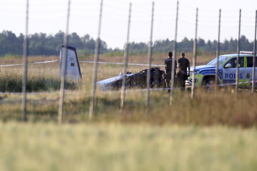 Emergency services at the scene of small aircraft crash, at Orebro Airport in Sweden, Thursday, July 8 2021. The airplane was used by the local parachute club with nine people on board. According to the police, multiple fatalites were reported. (Jeppe Gustafsson/TT News Agency via AP)