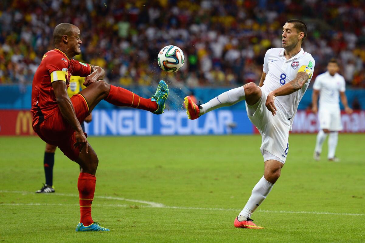 Vincent Kompany of Belgium and Clint Dempsey of the United States compete for the ball.