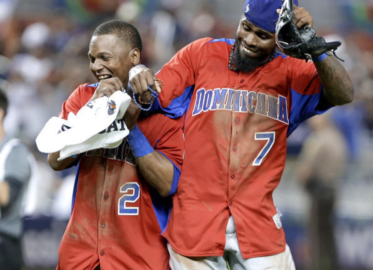 Dominican Republic shortstops Erick Aybar (2) and Jose Reyes (7) celebrate after a 3-1 victory over the U.S. in the second round of the World Baseball Classic.