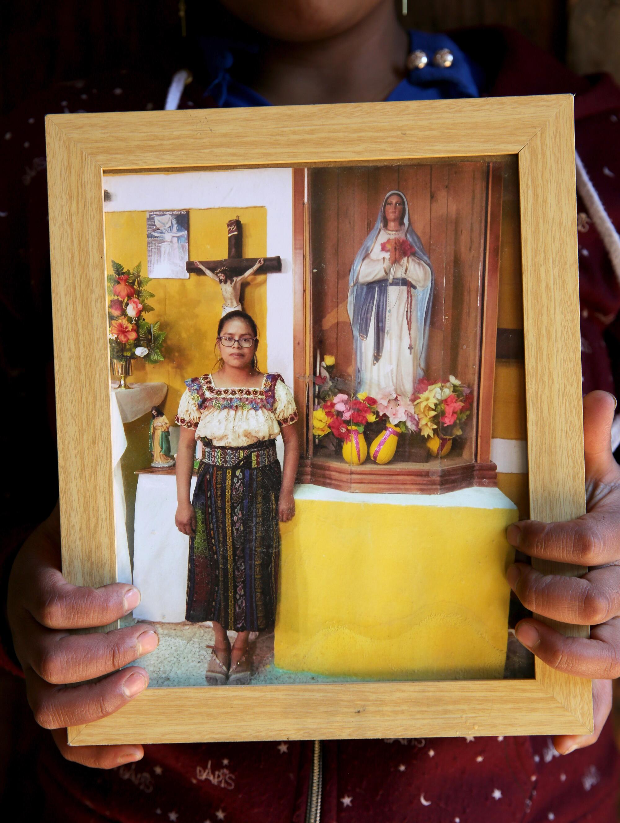 Portrait of Blanca Elizabeth Ramirez Crisostomo, who died at age 23, is held by her sister Glendy Araceli Rami