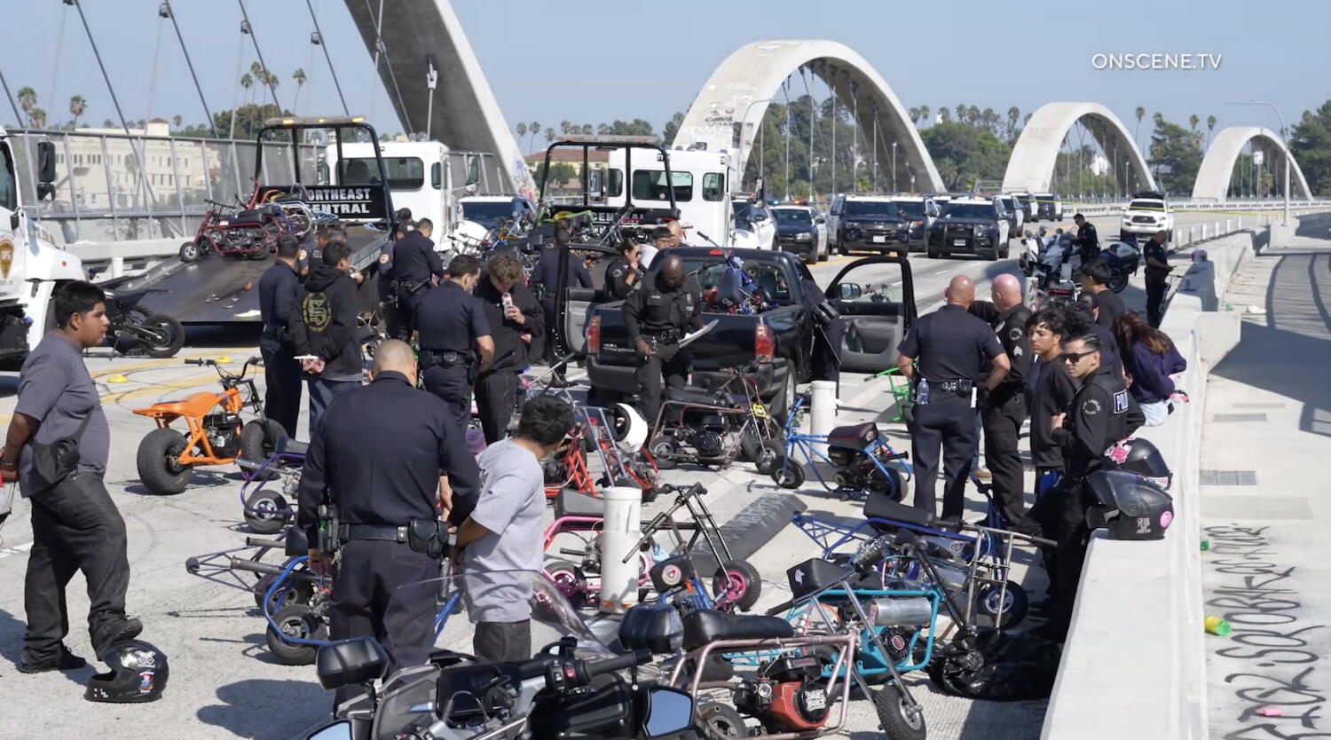 Scores of minibike riders penned in and arrested on 6th Street Bridge. They lost their bikes too