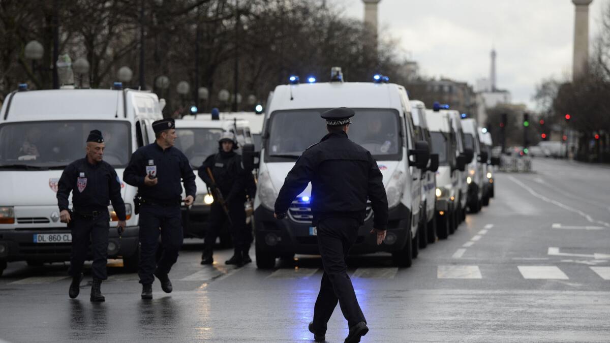 Police gather at the Porte de Vincennes in eastern Paris after a gunman opened fire at a kosher grocery store and took hostages.
