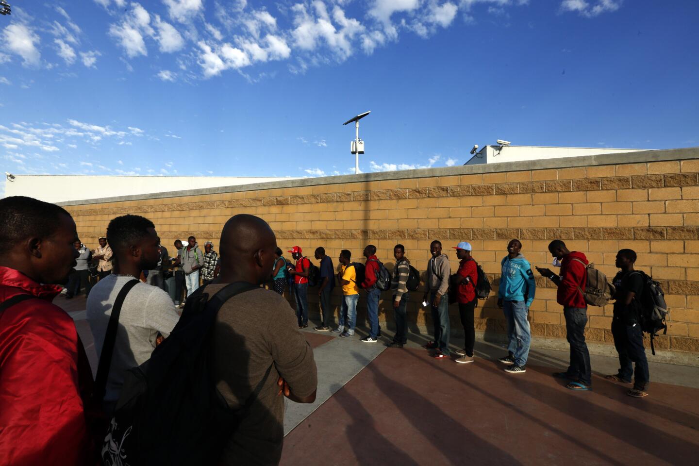 Migrantswait in line in Tijuana to enter the United States.