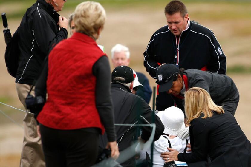 Condoleezza Rice bends down to check on a woman (in white) who was hit by Rice's wayward shot.