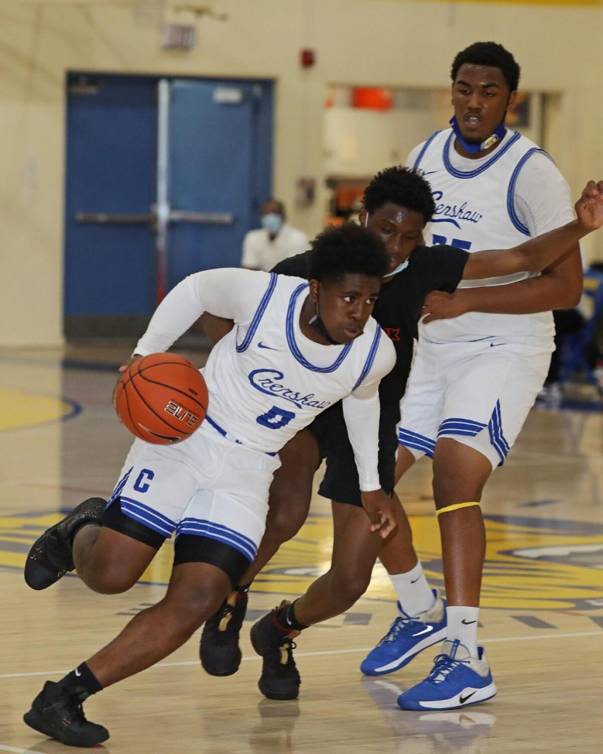 Kevin Bradley of Crenshaw drives against View Park Prep in a high school basketball game.