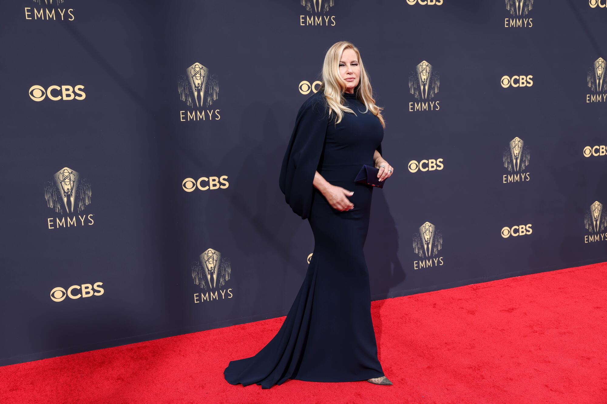 Jennifer Coolidge in a long-sleeved navy Christian Siriano gown.
