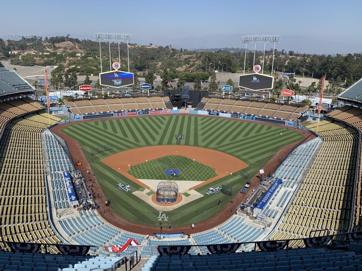 Dodger Stadium workers prep the field for Game 5 of the NLDS on Oct. 9, 2019.