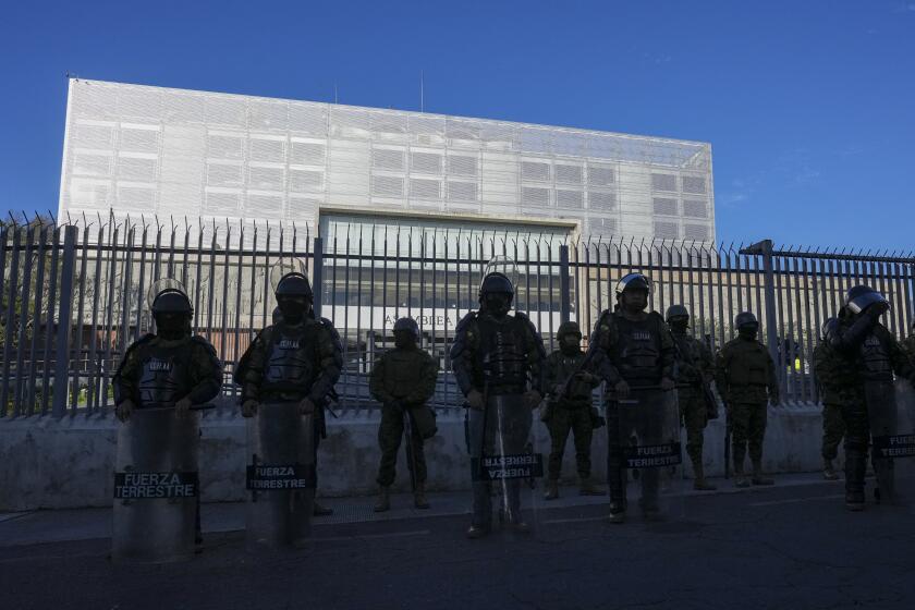 Soldiers guard the National Assembly in Quito, Ecuador, Wednesday, May 17, 2023. President Guillermo Lasso on Wednesday put an end to impeachment proceedings against him by dissolving the opposition-led National Assembly, which had accused him of embezzlement. (AP Photo/Dolores Ochoa)
