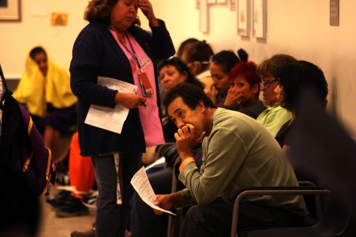 Patients wait for treatment at the Los Angeles County-USC Medical Center emergency room last October. A health official said L.A. County public hospitals are benefiting from an uptick in insured patients since the implementation of the federal Affordable Care Act this year.