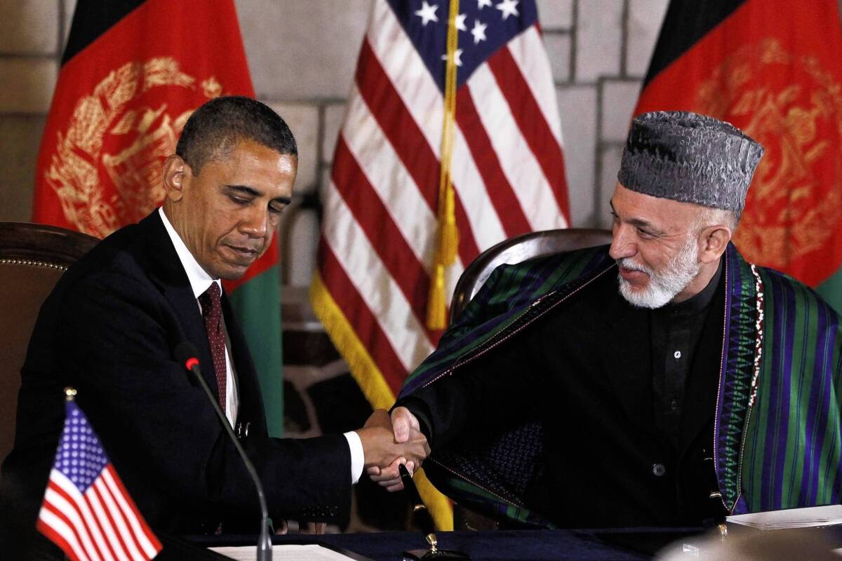 President Obama and Afghan President Hamid Karzai shake hands on May 2, 2012, before signing a strategic partnership agreement in Kabul, Afghanistan. Diplomats met again in Kabul on Saturday to work on the pact outlining the U.S. commitment to Afghanistan after 2014.