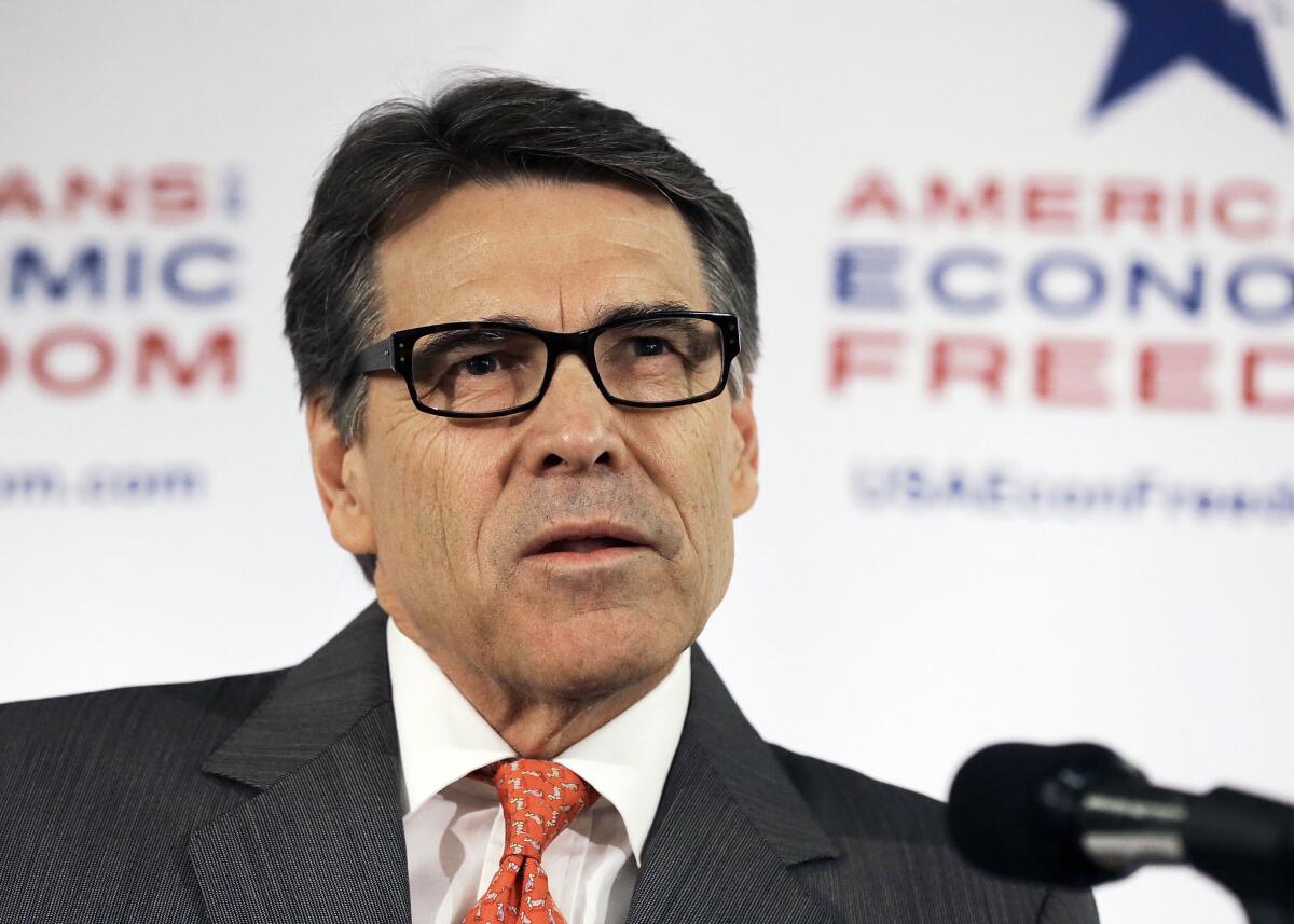 Texas Gov. Rick Perry speaks to reporters at a news conference at the California Republican Party convention in Anaheim on Friday.