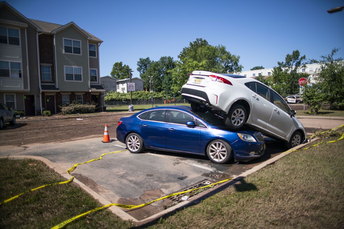 Cars are pilled after flooding as a result of the remnants of Hurricane Ida at Oakwood Plaza Apartments complex in Elizabeth, NJ., Thursday, Sept. 2, 2021. (AP Photo/Eduardo Munoz Alvarez)