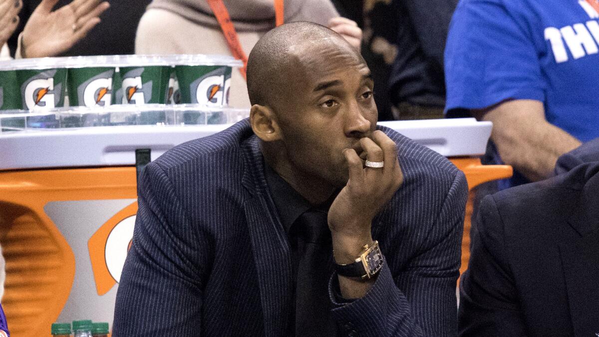 Kobe Bryant sits on the Lakers' bench watching the Thunder roll to a 118-78 victory Saturday.