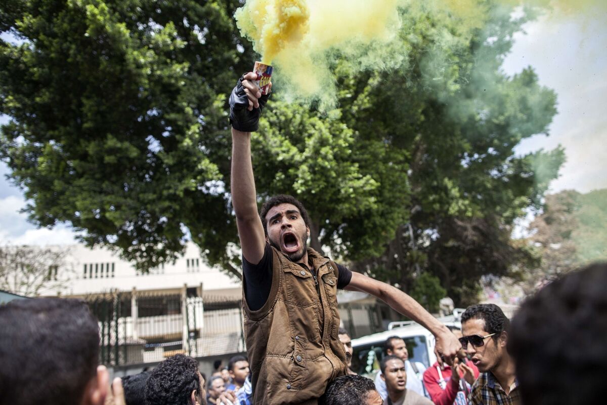 Egyptian students, supporters of the Muslim Brotherhood and ousted Islamist president Mohamed Morsi, demonstrate outside Cairo University, on April 9, 2014.