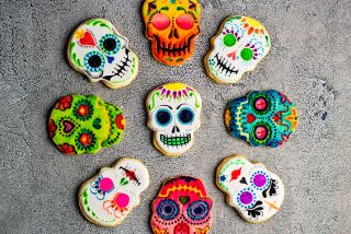 Cookies in the shape of skulls colorfully painted for Dia de Los Muertos.