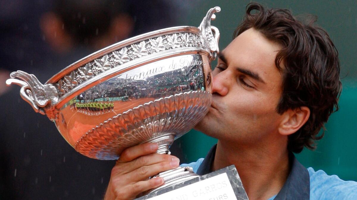 Roger Federer kisses the trophy after winning the French Open on June 7, 2009.