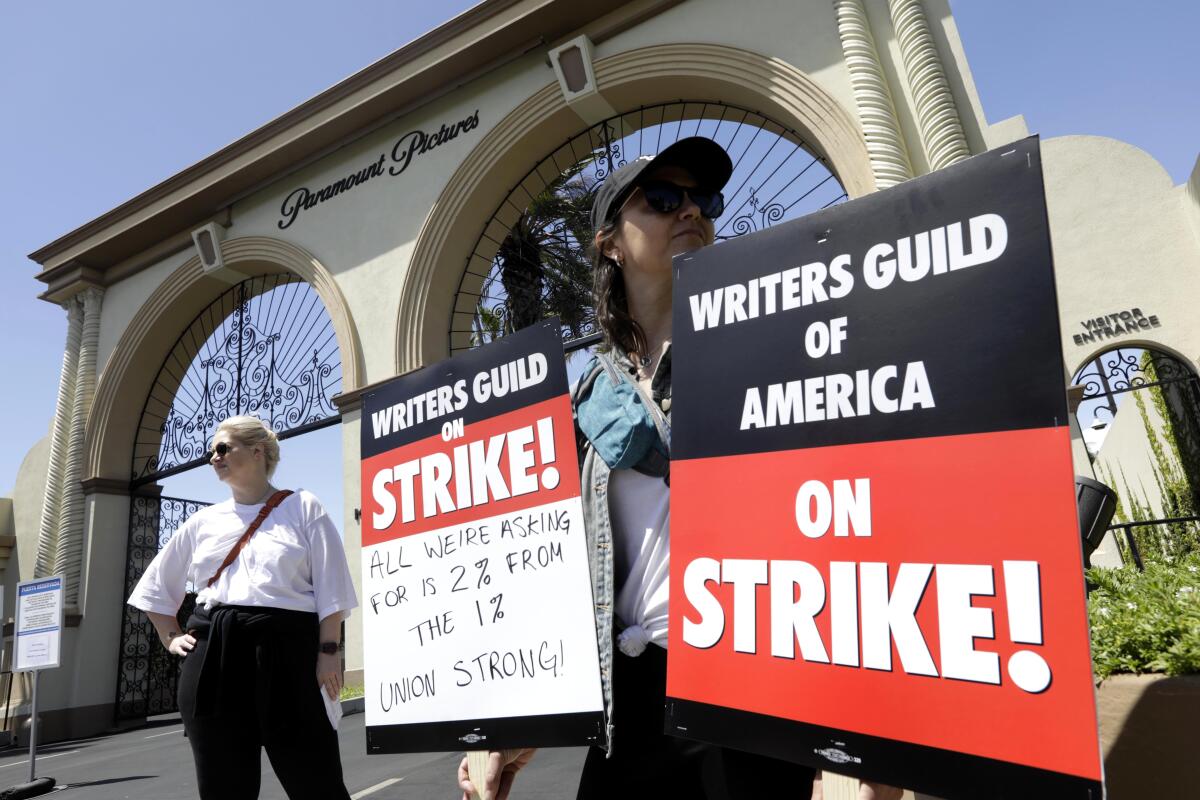 Protesters with signs outside Paramount Studios